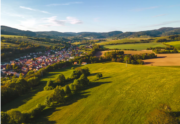 UK Farming supporting local economy - photo of a village with fields and housing